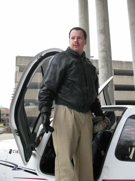 Yuri Kovchegov standing next to a plane