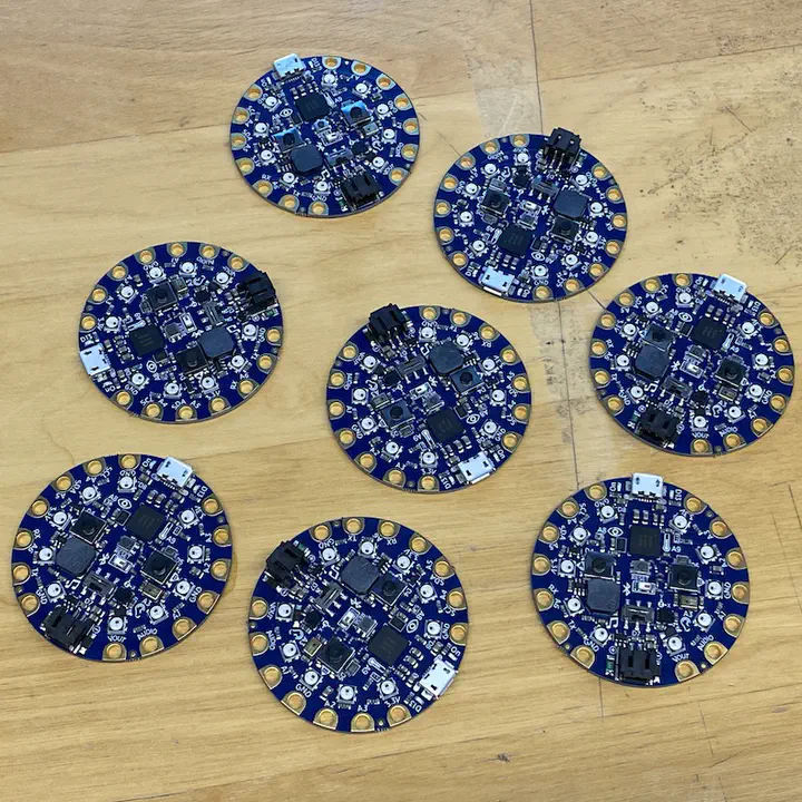8 round circuit boards on a table