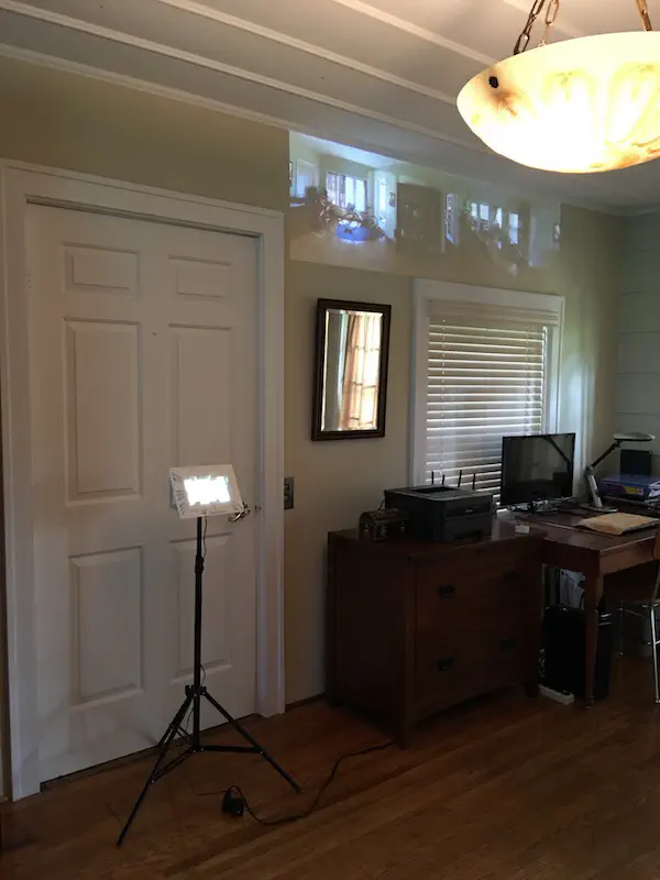 room with frame on stand and projection on wall